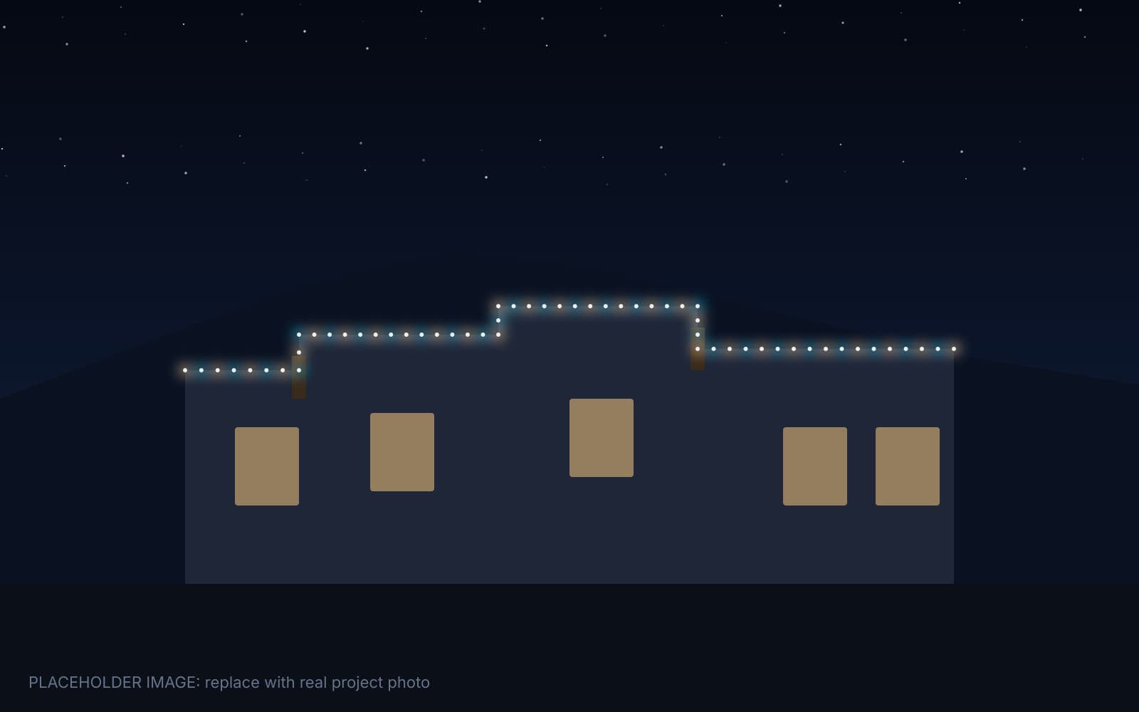 The same Albuquerque home at night with permanent lights glowing along the parapet